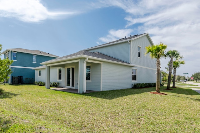 rear view of property with a lawn