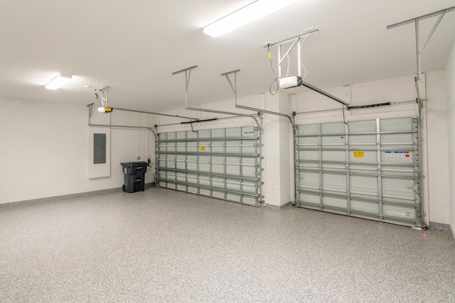 garage with a garage door opener and electric panel