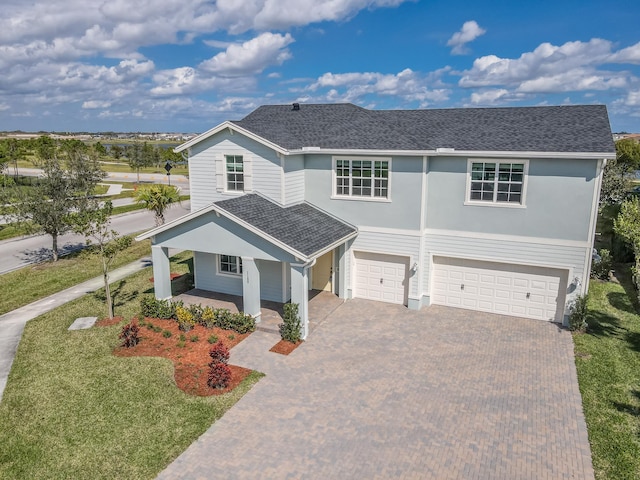 view of front of home featuring a garage and a front lawn