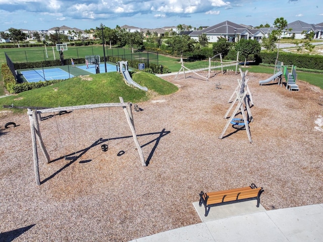 view of home's community with a playground and a yard