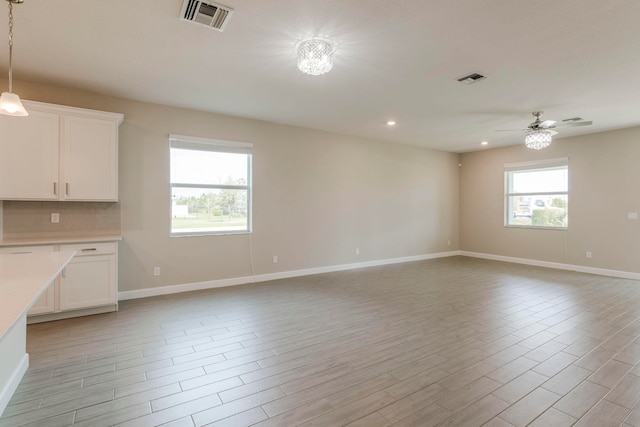 unfurnished living room featuring ceiling fan and light hardwood / wood-style floors