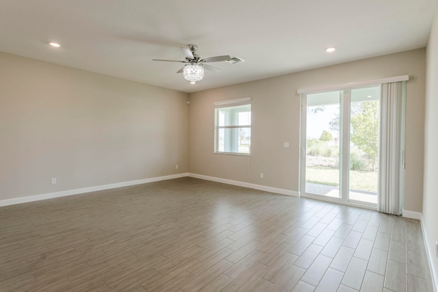 unfurnished room with light wood-type flooring and ceiling fan