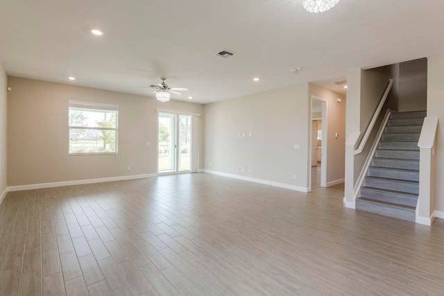 unfurnished living room with light hardwood / wood-style floors and ceiling fan