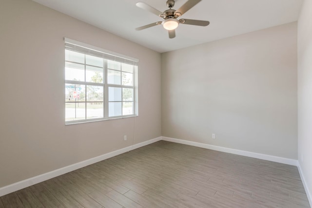 spare room with light wood-type flooring and ceiling fan