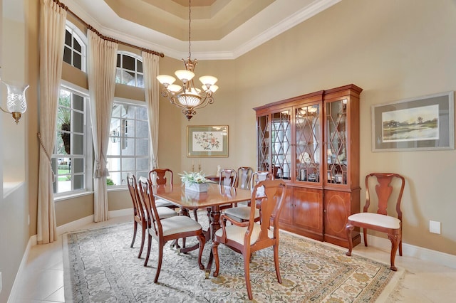 tiled dining space featuring an inviting chandelier, a high ceiling, plenty of natural light, and ornamental molding