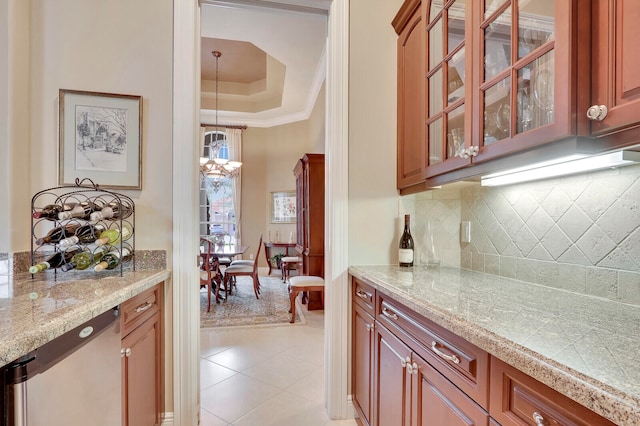 kitchen featuring an inviting chandelier, light tile patterned flooring, light stone countertops, and tasteful backsplash