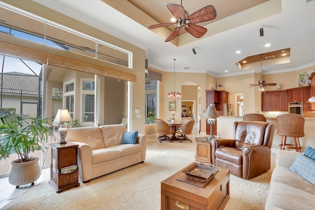 carpeted living room featuring a raised ceiling, crown molding, ceiling fan, and a wealth of natural light