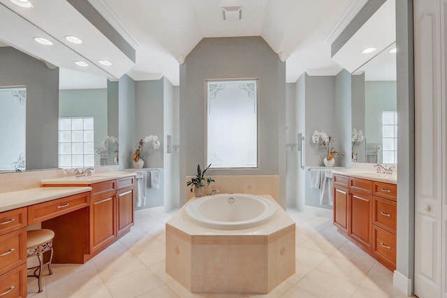 bathroom featuring vanity, tile patterned flooring, and a relaxing tiled tub