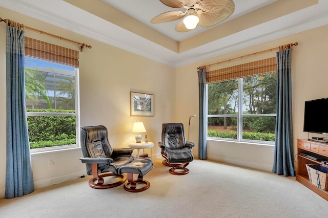 living area featuring carpet, crown molding, and plenty of natural light