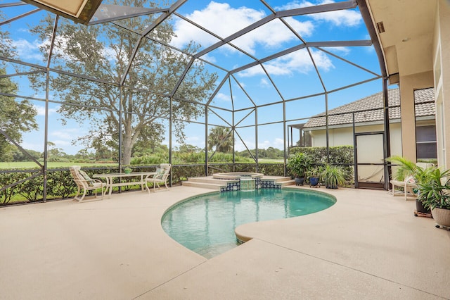 view of swimming pool with a lanai, a patio, and an in ground hot tub