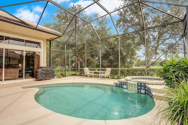 view of pool with area for grilling, an in ground hot tub, a lanai, and a patio area