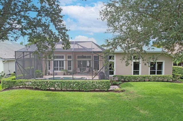 back of house featuring a lawn, a lanai, and a patio area