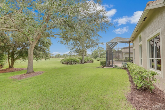 view of yard featuring glass enclosure