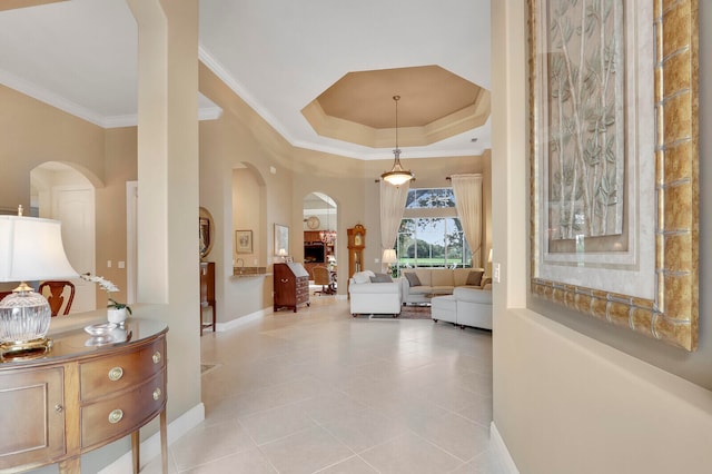 hallway featuring crown molding and light tile patterned floors