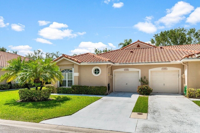 mediterranean / spanish-style house featuring a front yard and a garage