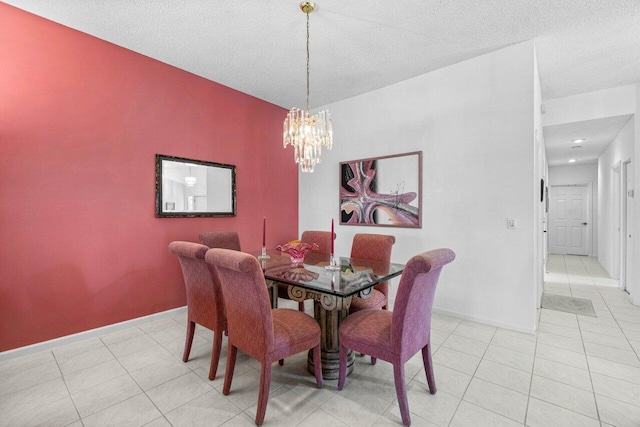 dining room with a notable chandelier, a textured ceiling, and light tile patterned floors