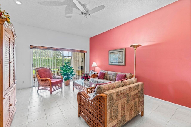 tiled living room with ceiling fan and a textured ceiling