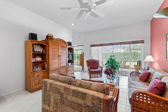 tiled living room featuring ceiling fan, a textured ceiling, and plenty of natural light