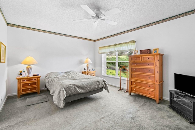 bedroom featuring ceiling fan, carpet floors, and a textured ceiling