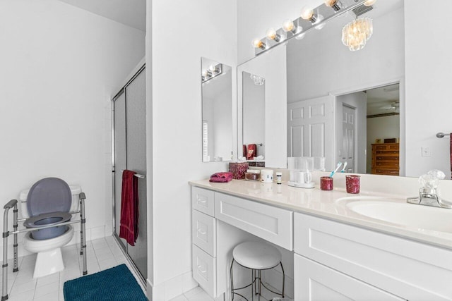 bathroom with tile patterned flooring, walk in shower, vanity, and toilet