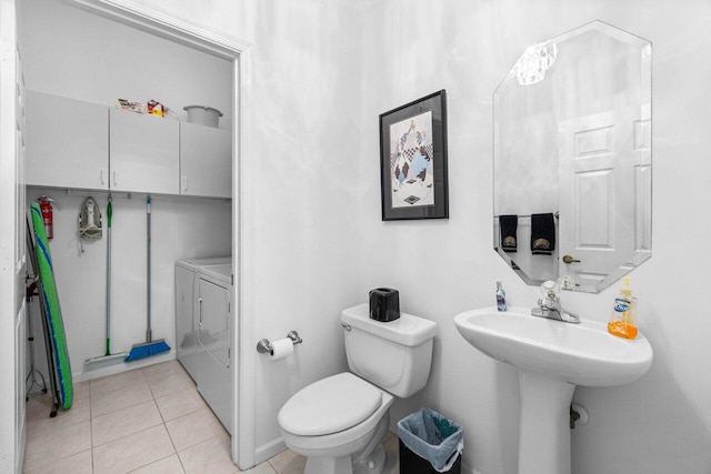 bathroom with separate washer and dryer, tile patterned flooring, and toilet