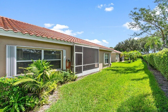 rear view of property featuring a lawn