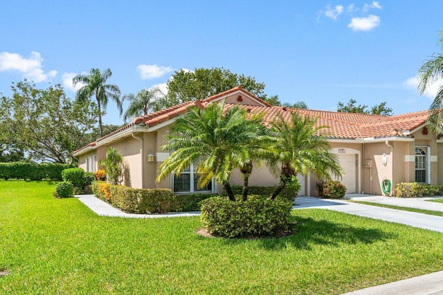 mediterranean / spanish-style home featuring a garage and a front lawn