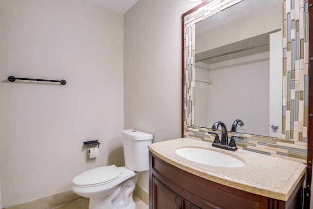 bathroom with toilet, tile patterned flooring, decorative backsplash, and vanity