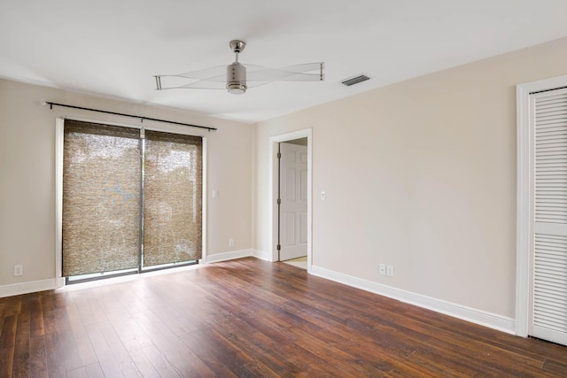 unfurnished bedroom featuring ceiling fan and dark hardwood / wood-style flooring