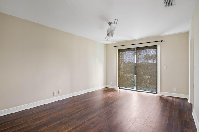 spare room with dark hardwood / wood-style floors