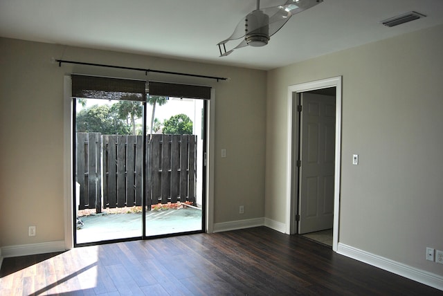 unfurnished room featuring dark wood-type flooring