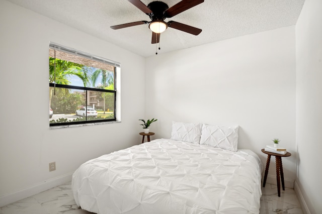 bedroom featuring a textured ceiling and ceiling fan