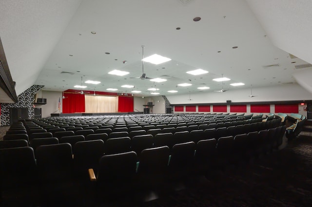 home theater room featuring ceiling fan and carpet flooring