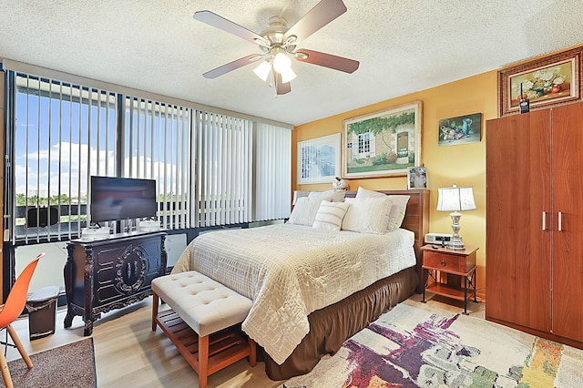 1401 S Federal Hwy Unit 411, Boca Raton, FL 33432 - bedroom featuring light wood-style floors, ceiling fan, a textured ceiling, and multiple windows
