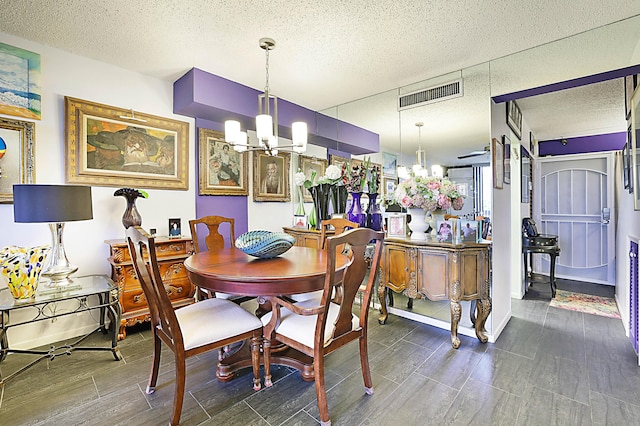 1401 S Federal Hwy Unit 411, Boca Raton, FL 33432 - dining space with a textured ceiling, wood finished floors, visible vents, and an inviting chandelier