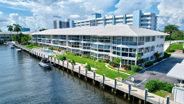 view of property featuring a water view and a community pool