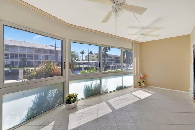 unfurnished sunroom featuring ceiling fan