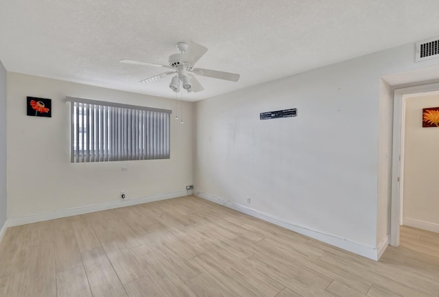 empty room featuring ceiling fan, a textured ceiling, and light hardwood / wood-style flooring