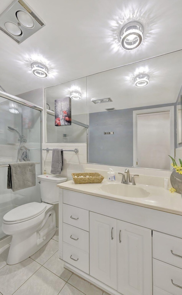 bathroom featuring toilet, a shower with shower door, vanity, and tile patterned flooring