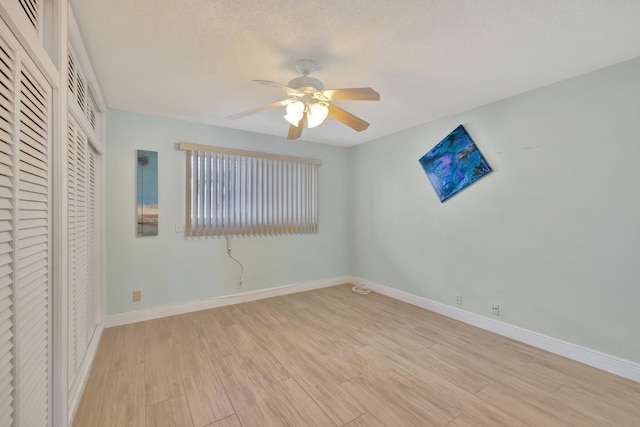 unfurnished bedroom featuring a closet, light wood-type flooring, and ceiling fan