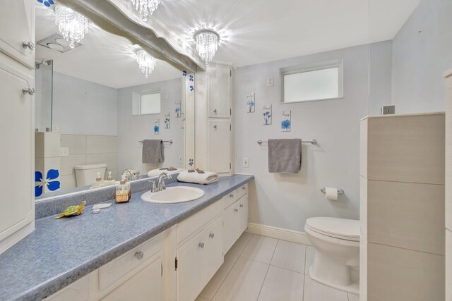 bathroom featuring vanity, toilet, and tile patterned flooring