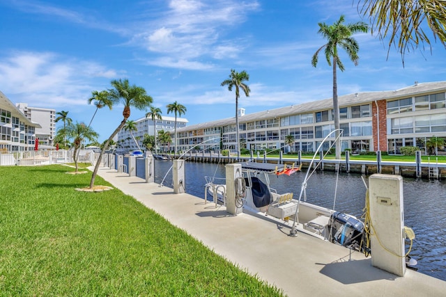 view of dock featuring a yard and a water view