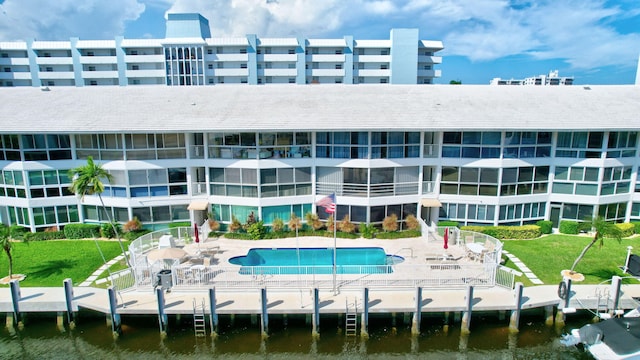 exterior space featuring a community pool and a water view