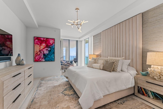 bedroom featuring a chandelier and access to exterior