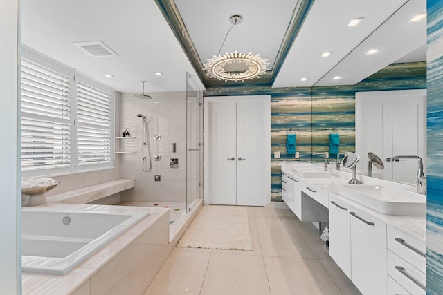 bathroom with a notable chandelier, vanity, plus walk in shower, and tile patterned floors