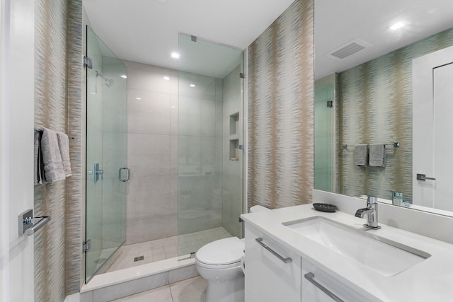 bathroom with walk in shower, vanity, toilet, and tile patterned floors