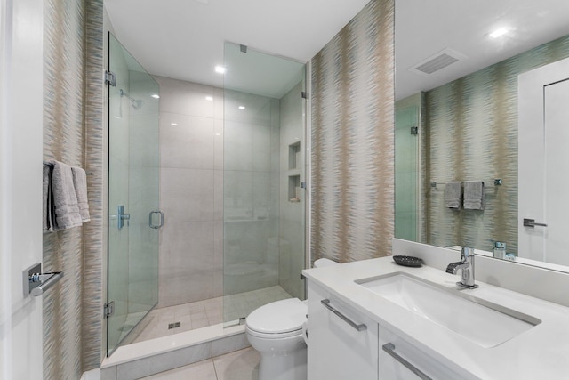 5000 N Ocean Dr Unit 1003, Singer Island, FL 33404 - bathroom featuring vanity, toilet, a shower stall, tile patterned floors, and wallpapered walls