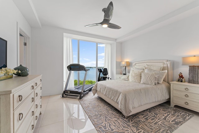 tiled bedroom with access to outside, a water view, and ceiling fan