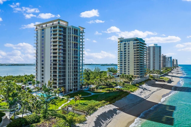 view of building exterior with a water view and a view of the beach