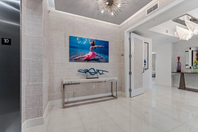 hallway featuring a notable chandelier and tile patterned flooring